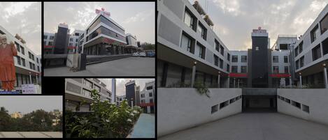 A hotel with a modern design, featuring a reception area, multiple floors, and a view of the surrounding cityscape.
