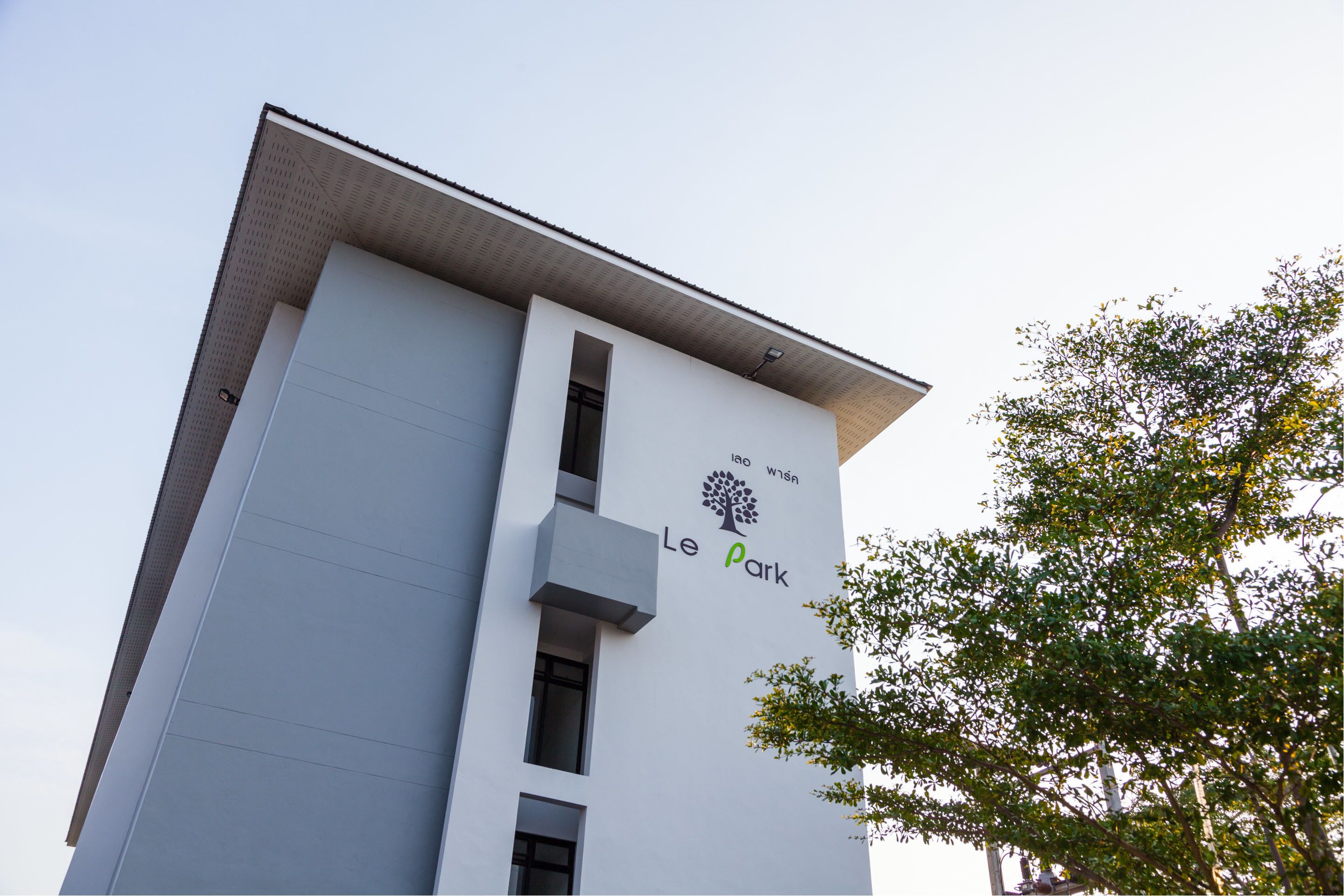 A modern building with a sign that reads "Le Park" and a tree logo.