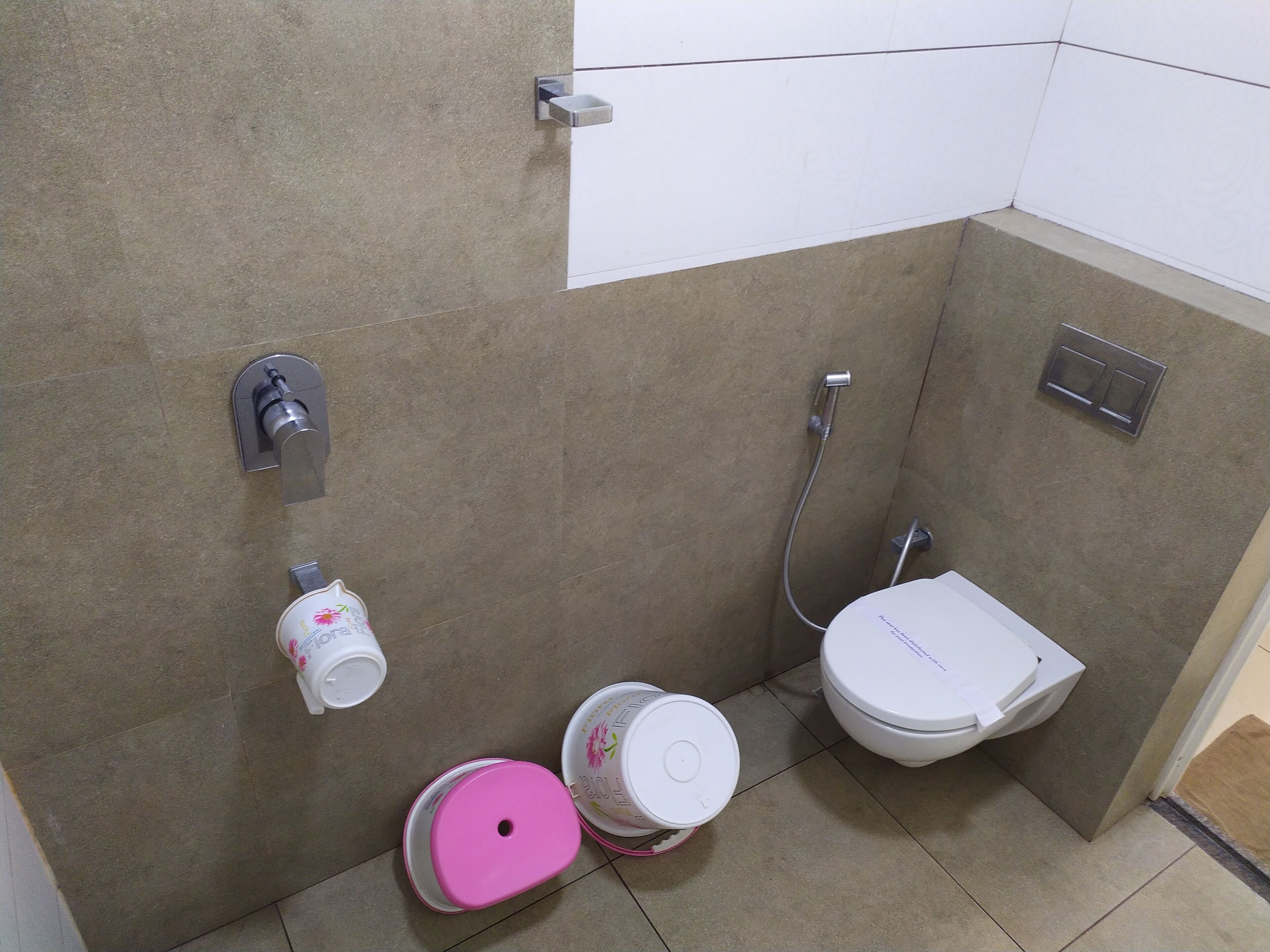 A small bathroom with a toilet, a shower, and a sink.