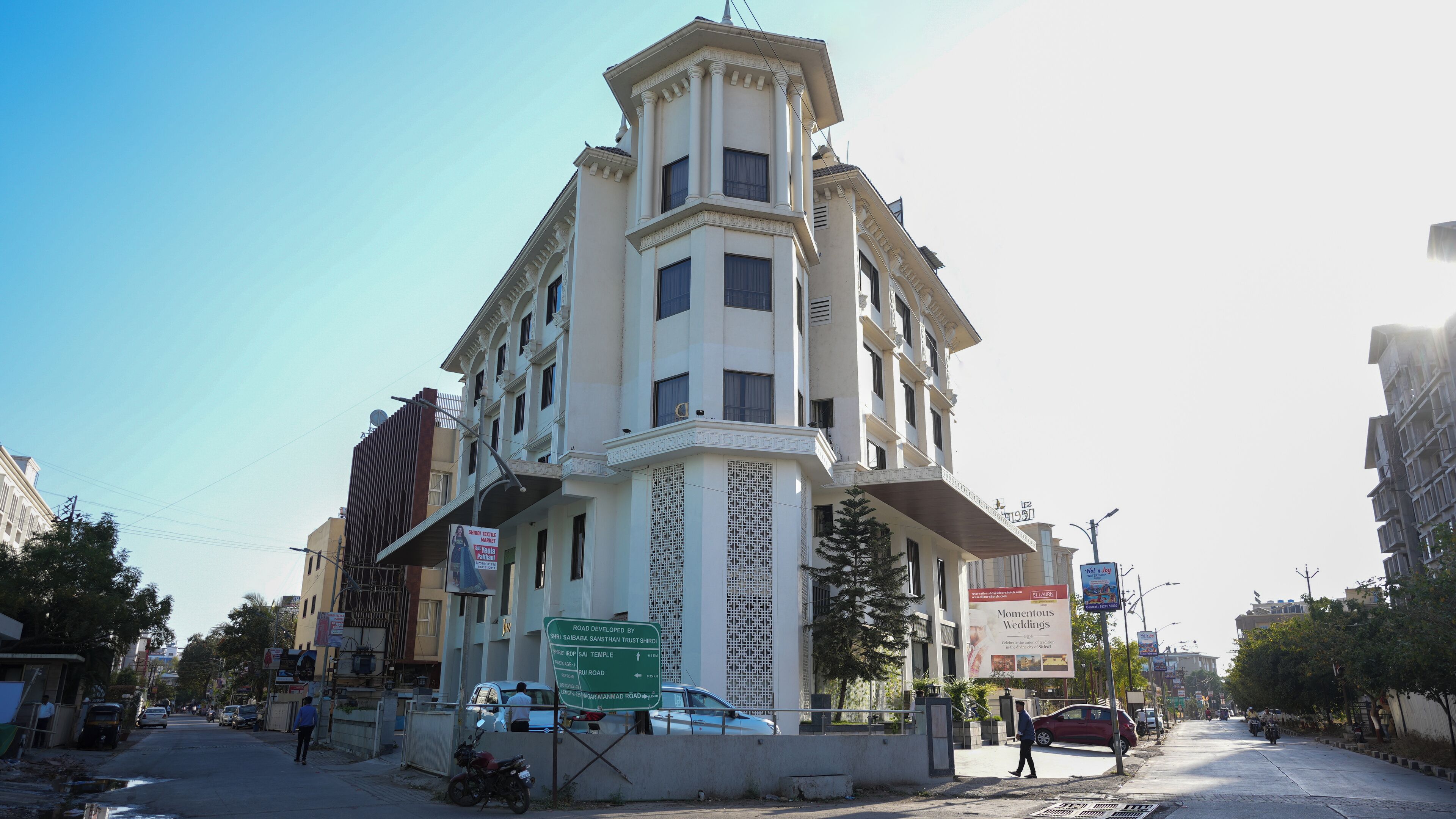 A multi-story building with a central tower, large windows, and a prominent entrance.