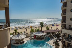 A pool area with a view of the beach and ocean. - Menada Golden Rainbow Apartments (Sunny Beach)