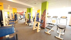 A gym with various exercise equipment, including treadmills and weight machines. - Menada Grand Kamelia Apartments (Sunny Beach)