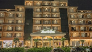 A multi-story hotel with balconies, a central entrance with a sign, and a pharmacy sign visible on the ground floor. - Menada Diamant Residence Apartments (Sunny Beach)