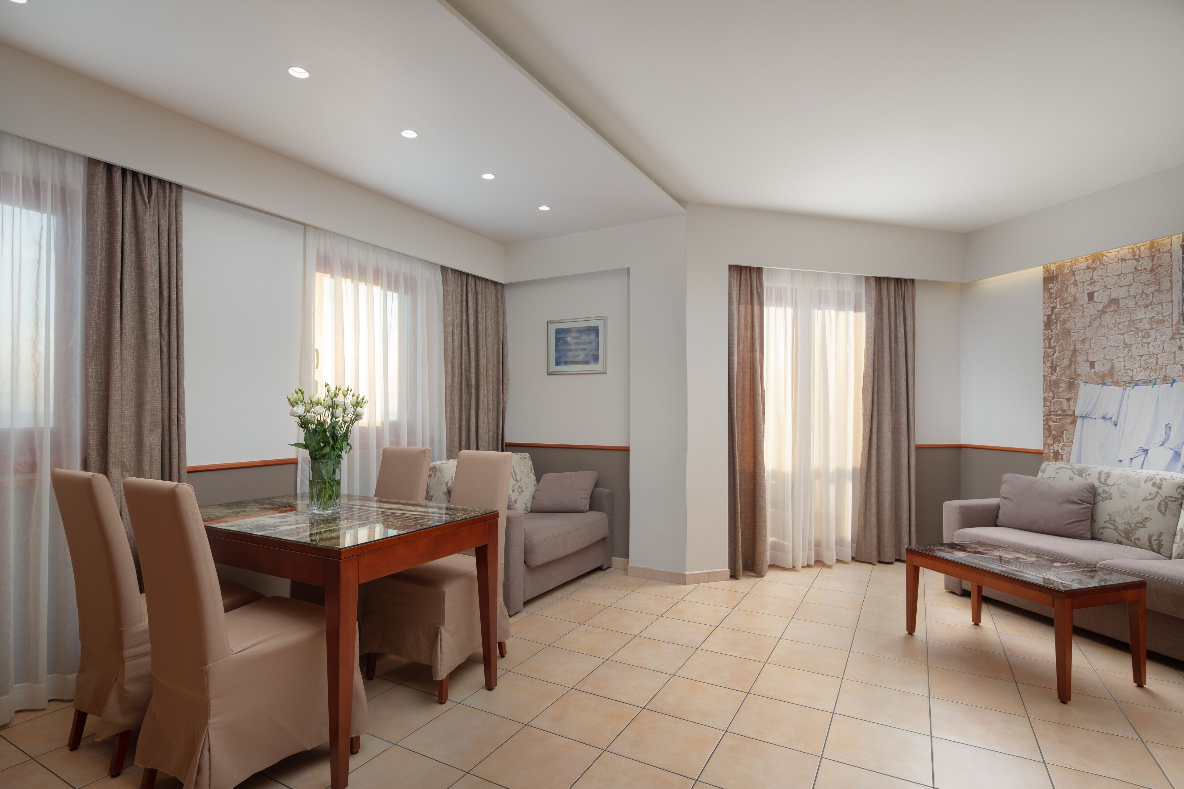 A modern living room with a dining table, two sofas, and a coffee table.