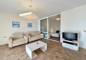 Deluxe-Apartment, Meerblick | Wohnzimmer | 30-cm-Flachbildfernseher mit Kabelempfang