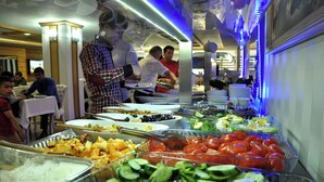 A buffet with various food options including fruits, vegetables, and salads. - The Ancient Mesopotamia Hotel (Batman)