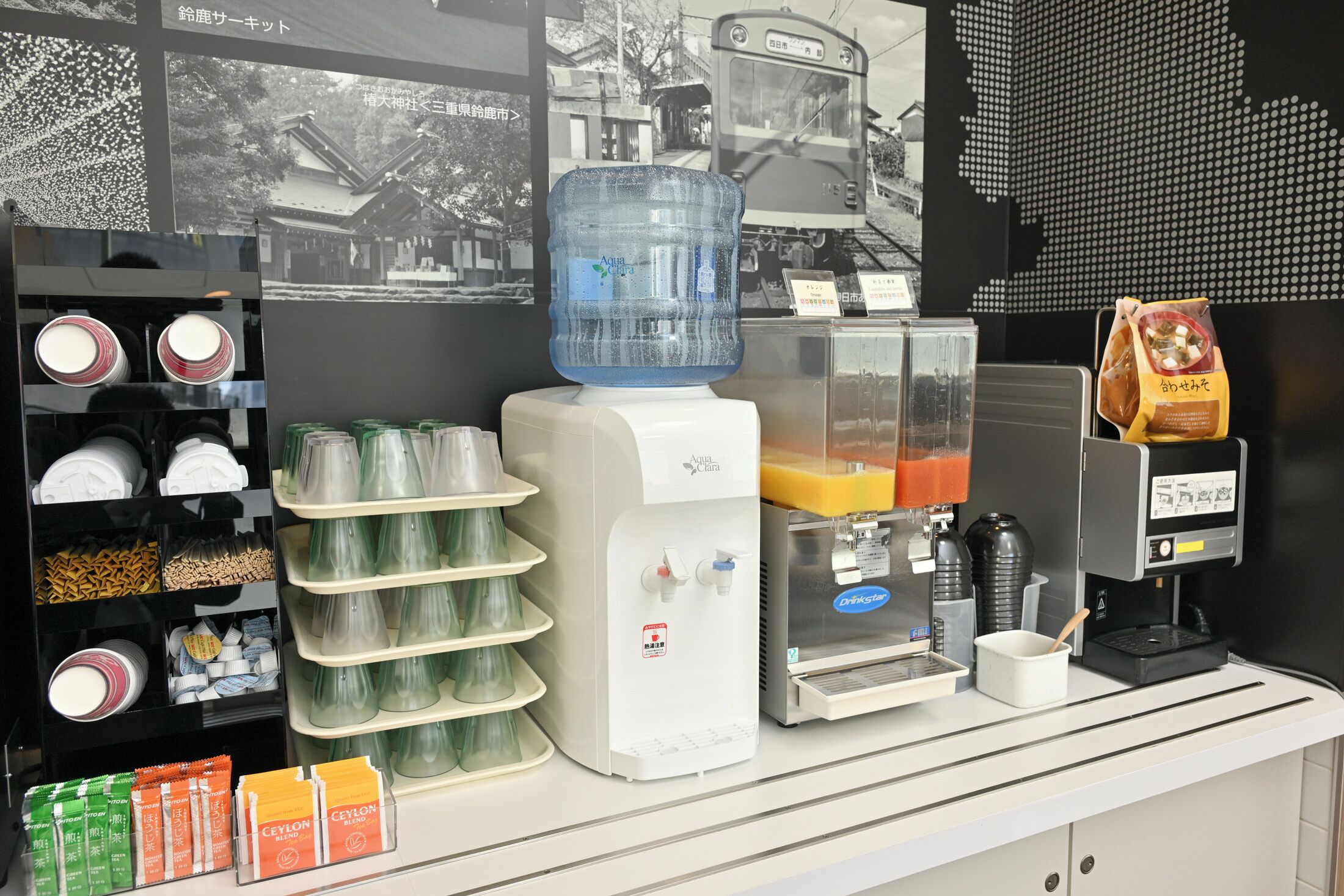 A beverage station with a water dispenser, coffee machine, and a juice dispenser.