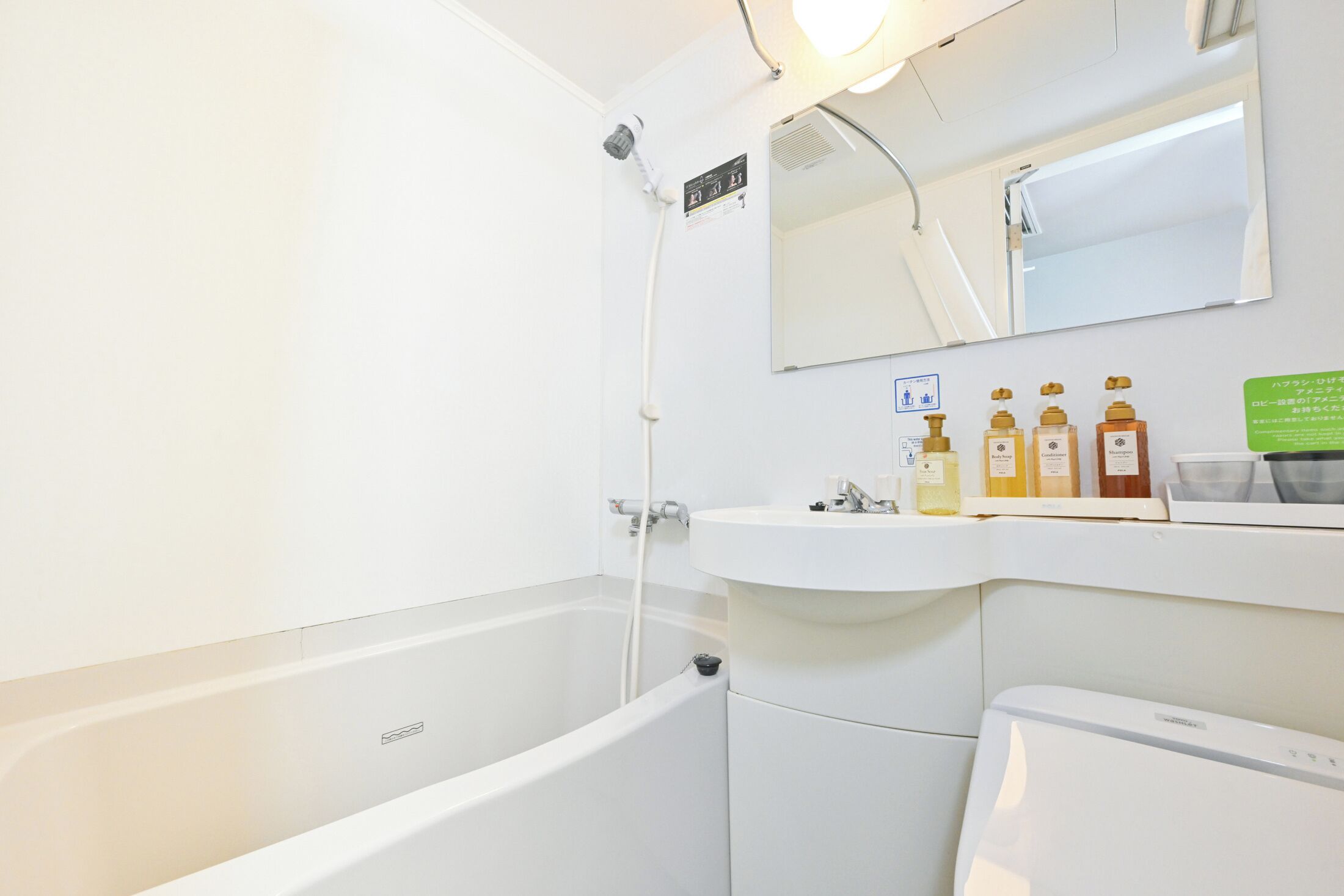 A modern bathroom with a bathtub, a sink, and a mirror.