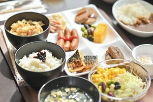 A variety of dishes on a tray, including rice, fish, and vegetables.