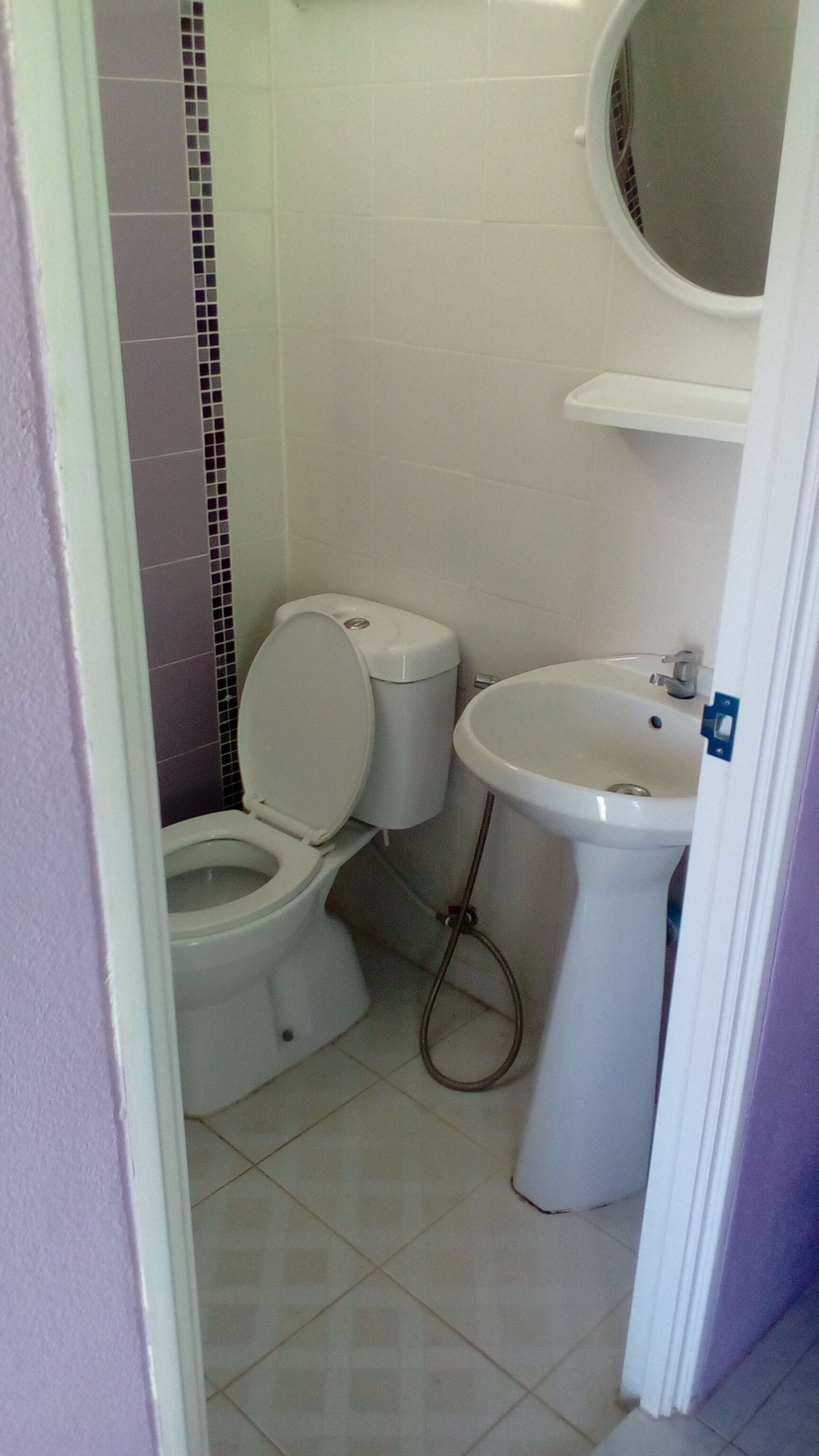 A bathroom with a toilet, bidet, and sink.