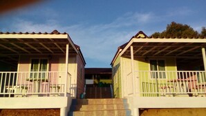 Two adjacent houses with a shared staircase leading to a common entrance. - Lovely Farm (Khao Kho)