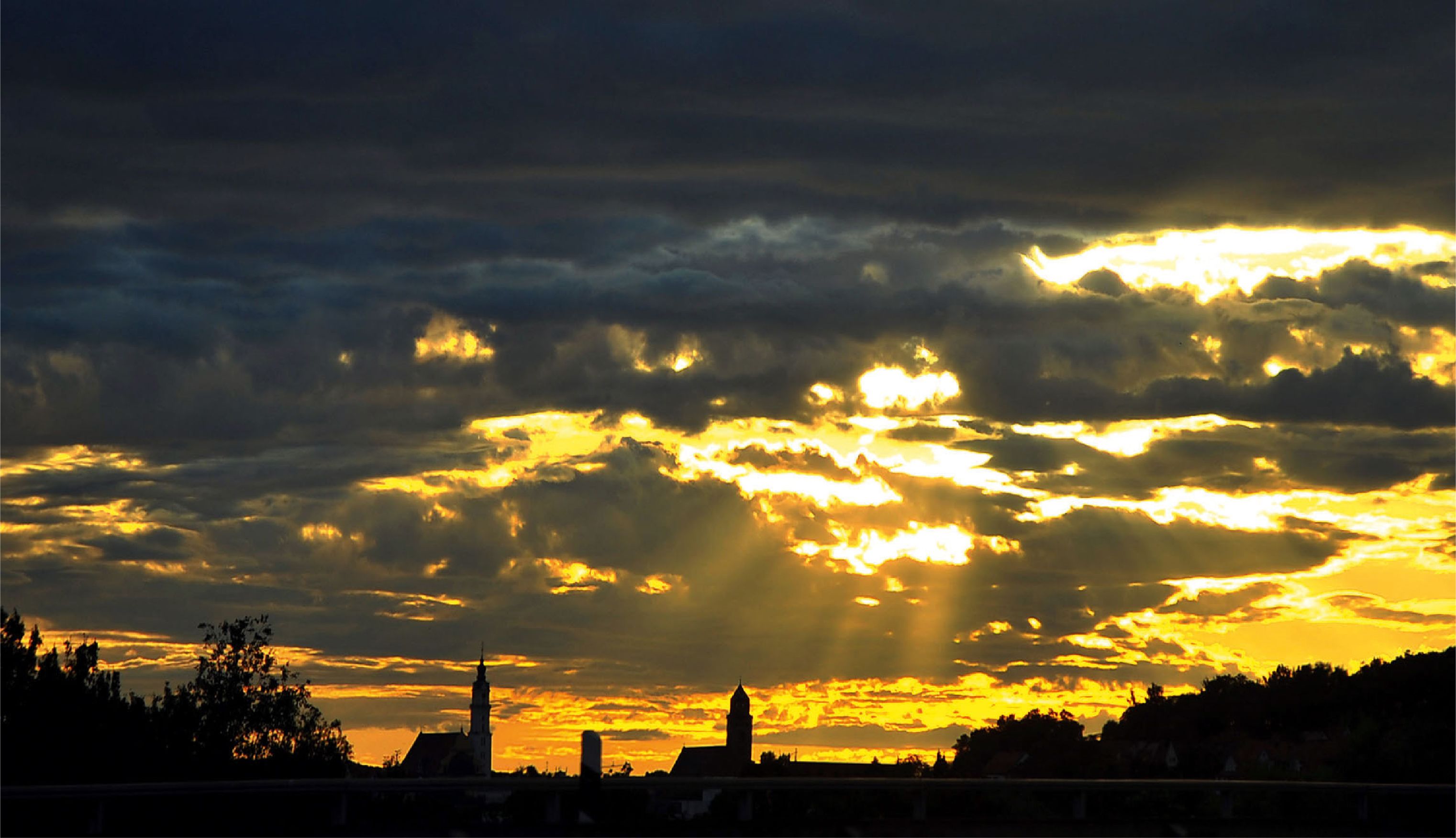 Un horizonte urbano al atardecer, con edificios destacados recortados contra un cielo vibrante.