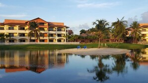 A resort with multiple-story buildings, a central water feature, and palm trees. - TOT Punta Cana Apartments (Punta Cana)