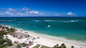On the beach, white sand, sun-loungers, beach umbrellas