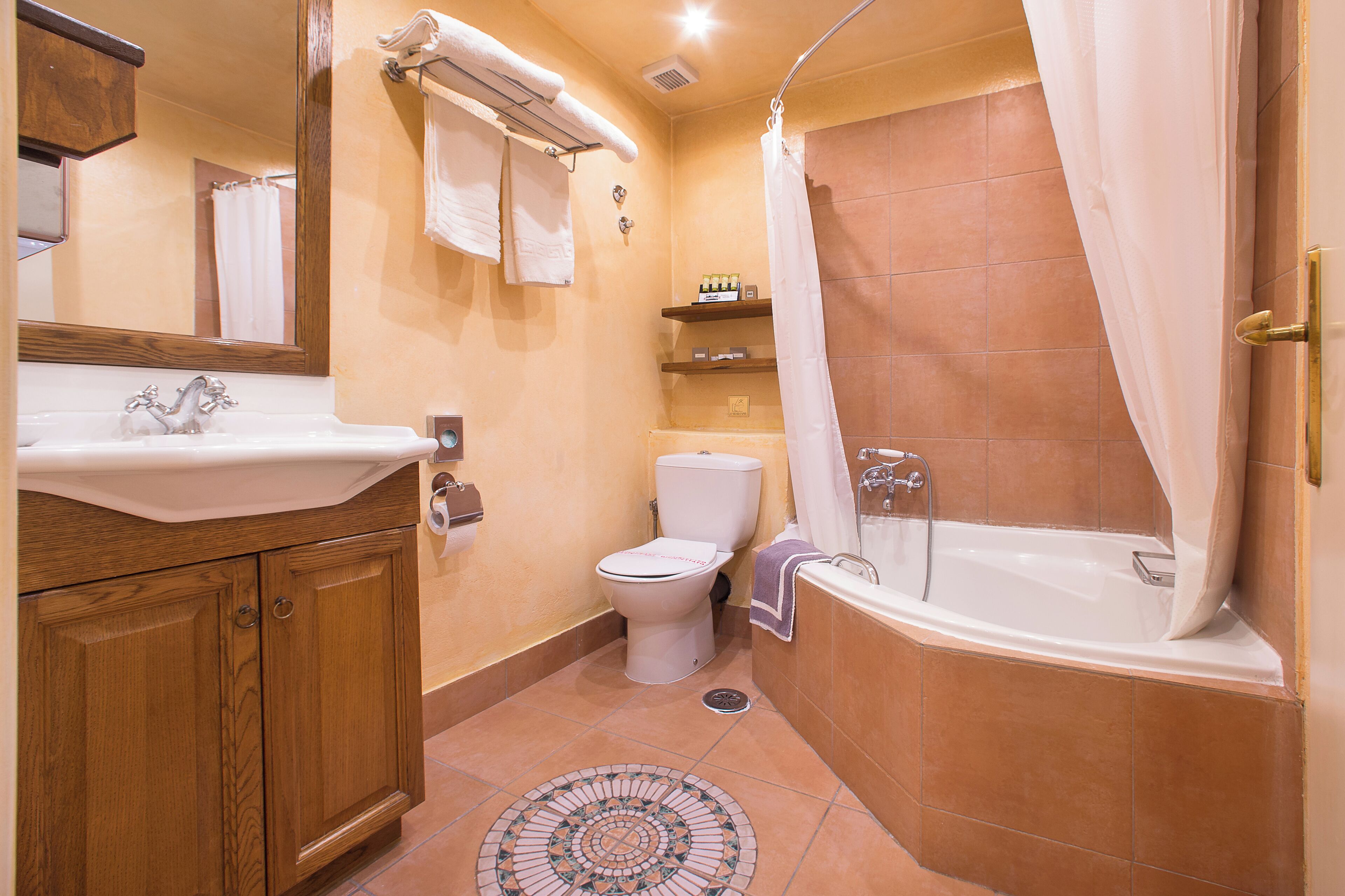 A bathroom with a sink, toilet, and bathtub.