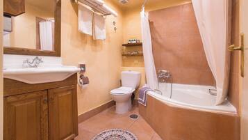A bathroom with a sink, toilet, and bathtub.