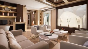 A modern living room with a fireplace, comfortable seating, and a large window with decorative vases. - Quinta Real Granada (Huetor Vega)