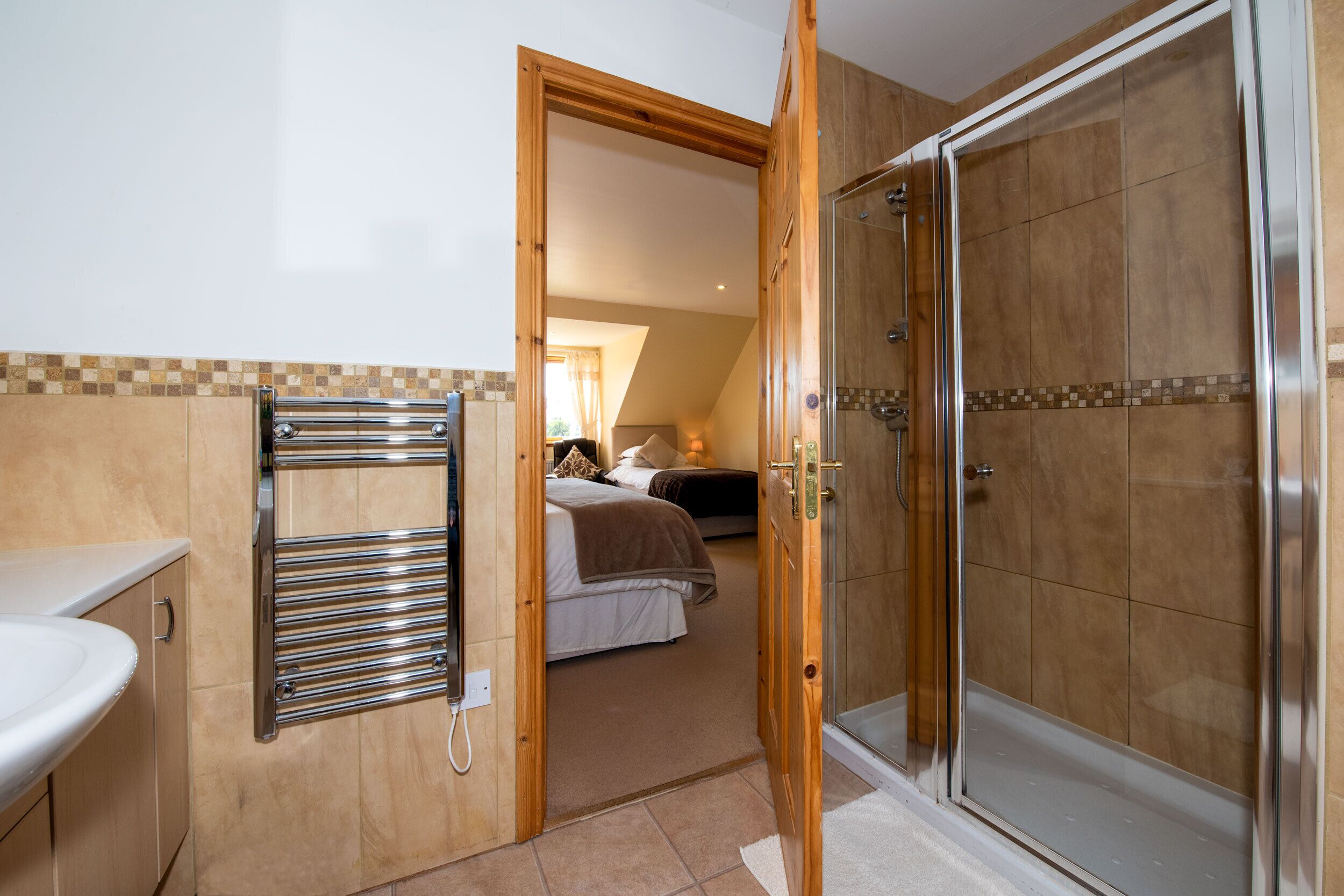 Ein Badezimmer mit Dusche, Handtuchhalter und Waschbecken.