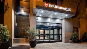 The exterior of Best Western PLUS hotel with a large entrance, potted plants, and a clear sign. - Best Western Plus Philadelphia Convention Center Hotel (Philadelphia)