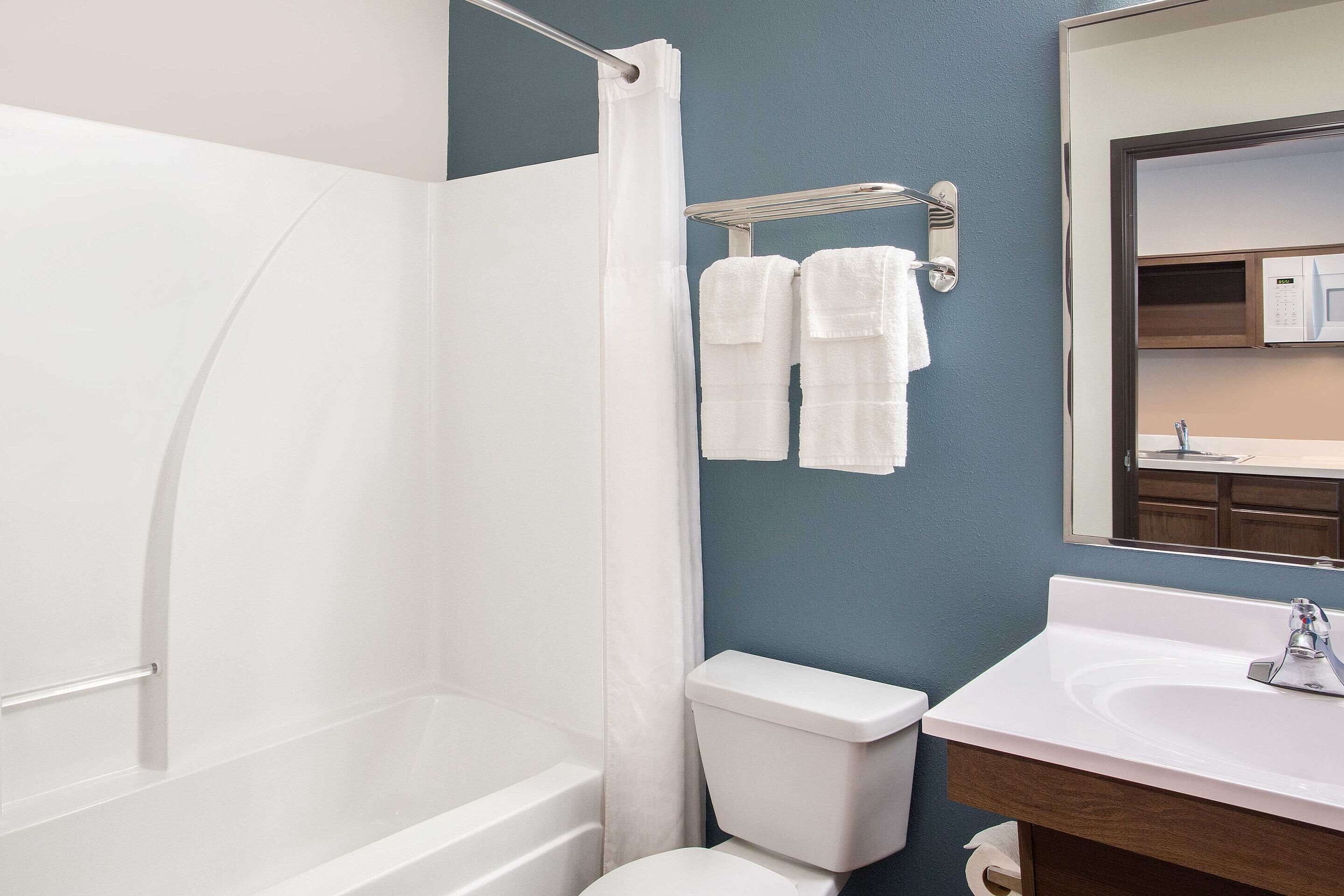 A bathroom with a bathtub, toilet, and sink.