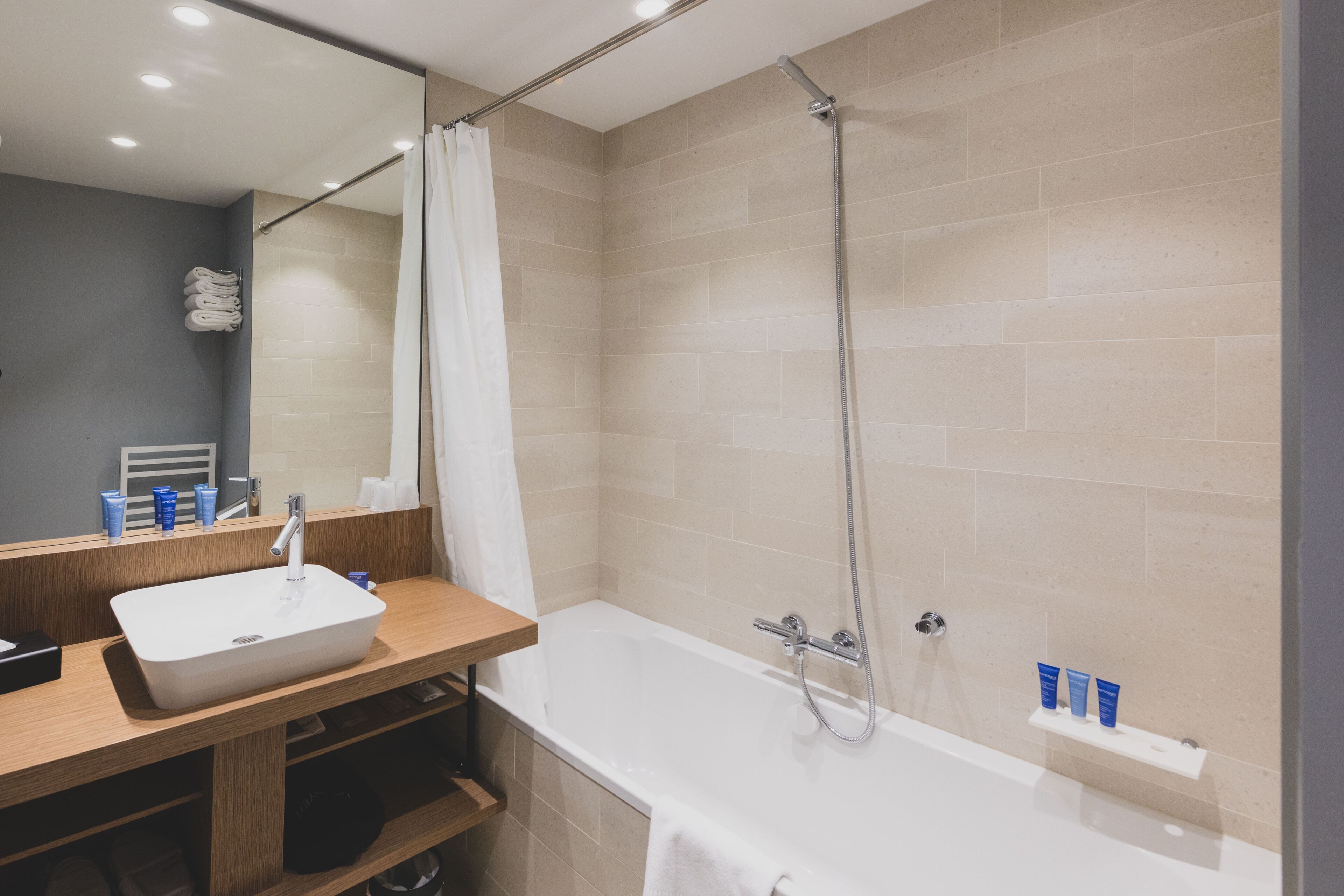 junior suite, multiple beds | bathroom | eco-friendly toiletries, hair dryer, slippers, towels