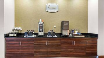 A breakfast bar with a coffee machine, tea station, and a sign for 'Morning Medley Breakfast'.