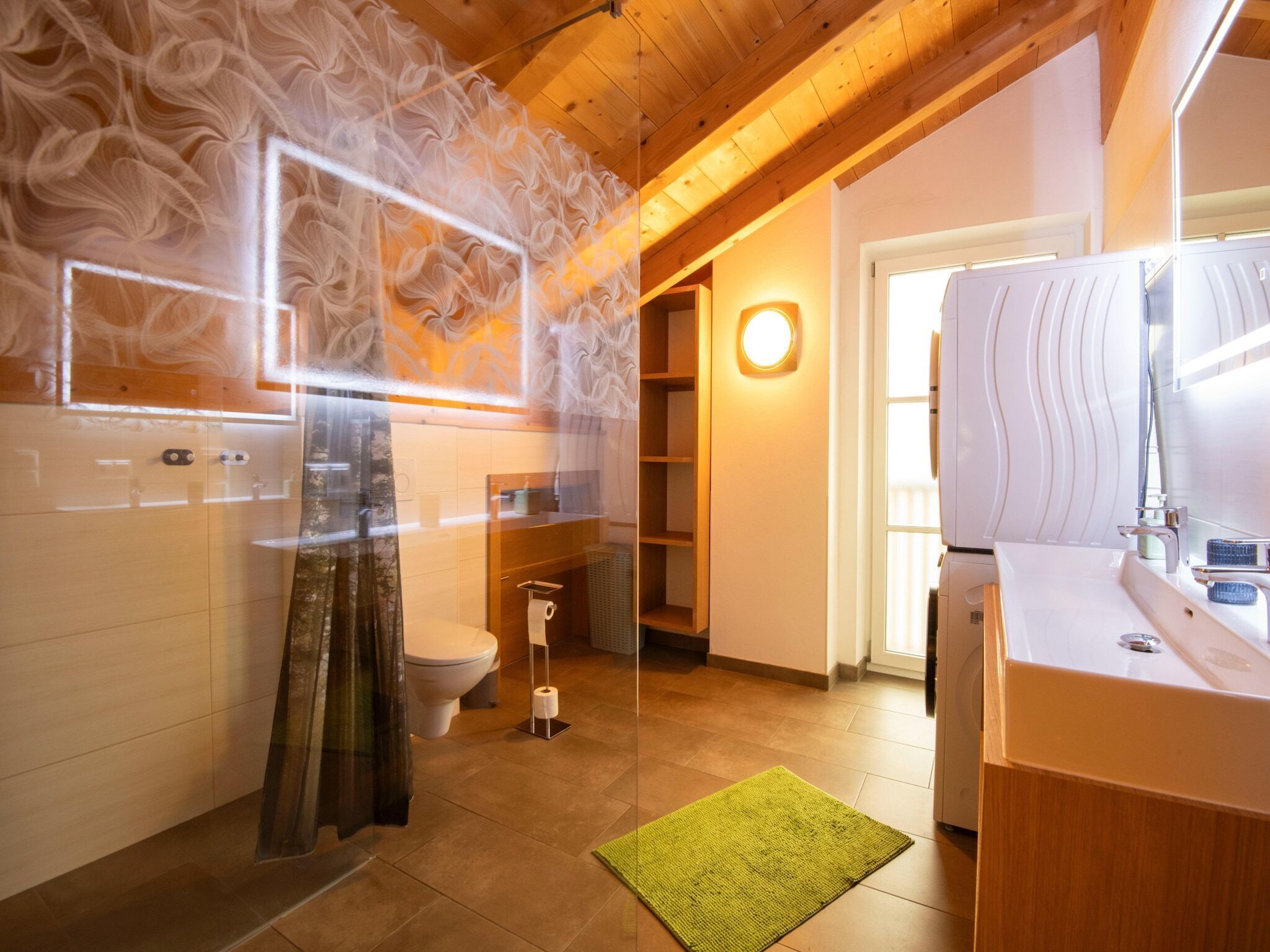A modern bathroom with a wooden ceiling, a white sink, and a toilet.