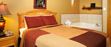 A neatly made bed with a quilt, a bedside lamp, and a nightstand with a basket.