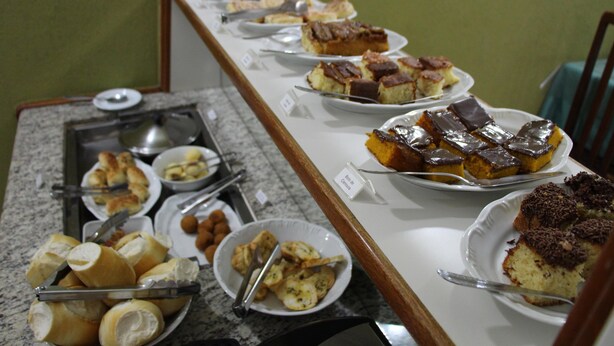 A buffet table with various desserts and pastries. - Paradise Hotel (Campo Grande)