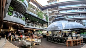 A modern indoor public space with multiple levels, seating areas, and a bar. - The Crystal Luxury Bay Resort Nusa Dua (Nusa Dua)