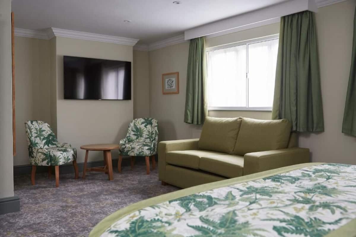 Desk, iron/ironing board, bed sheets