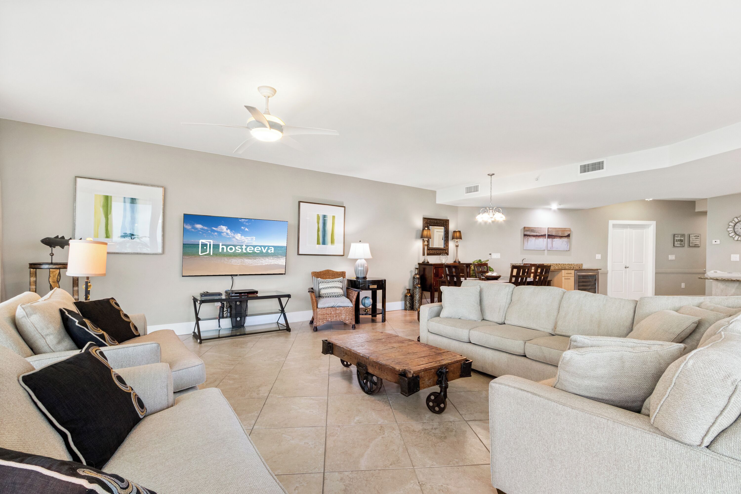 A spacious living room with a large sofa, a coffee table, and a television.