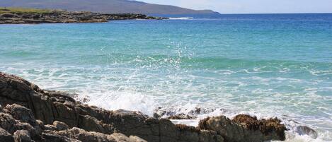 A coastal landscape with rocky shores and calm sea.