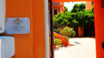 A sign for D.M. Luxury Suites with contact information and a website URL.