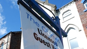 A sign for The Chimes Guest House, including the name, a telephone number, and a website URL. - The Chimes (Bridlington)