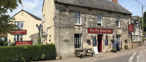 A traditional stone building with a sign for 'The Old Pound Inn.'