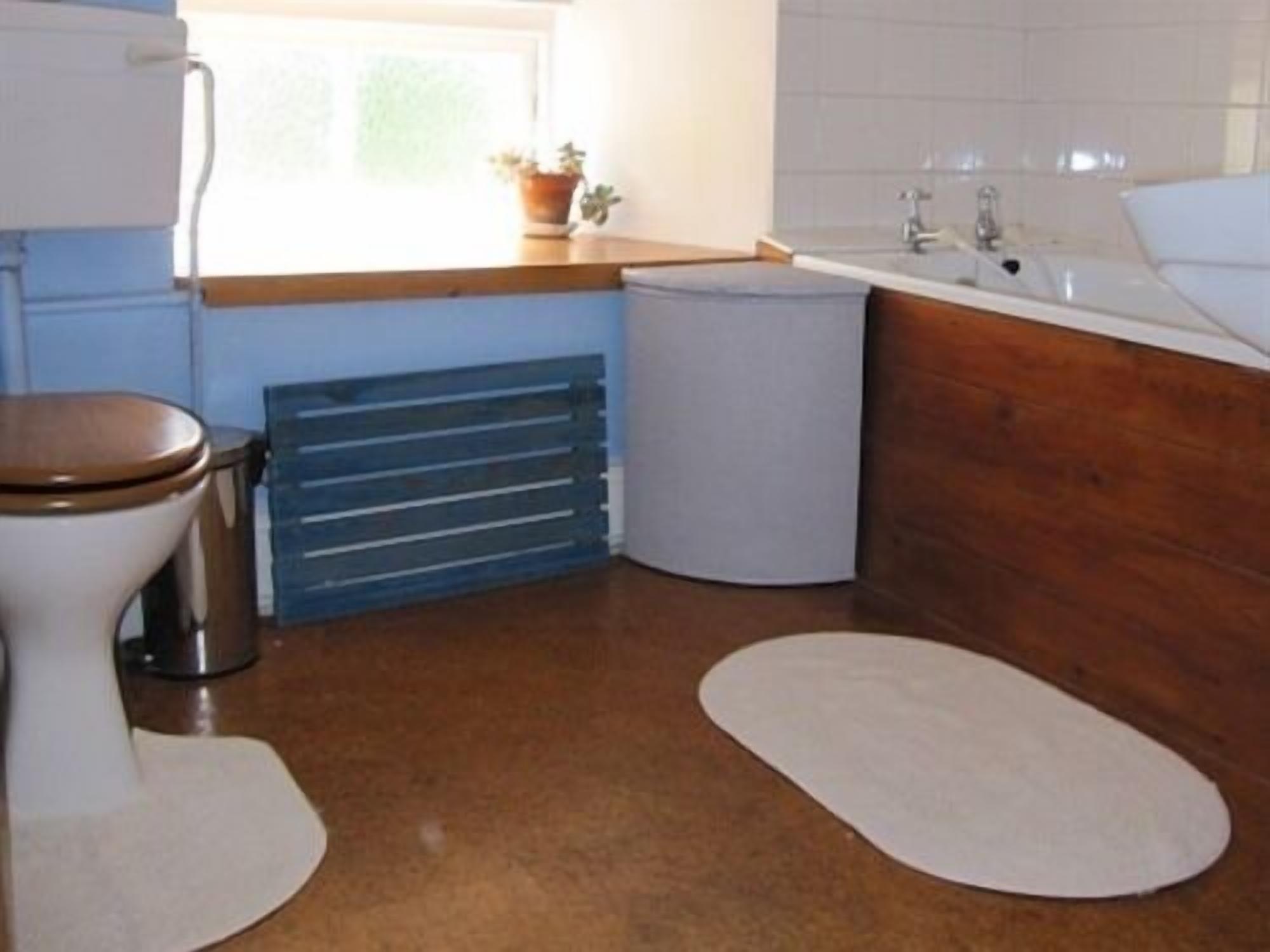 A bathroom with a toilet, sink, and bathtub.