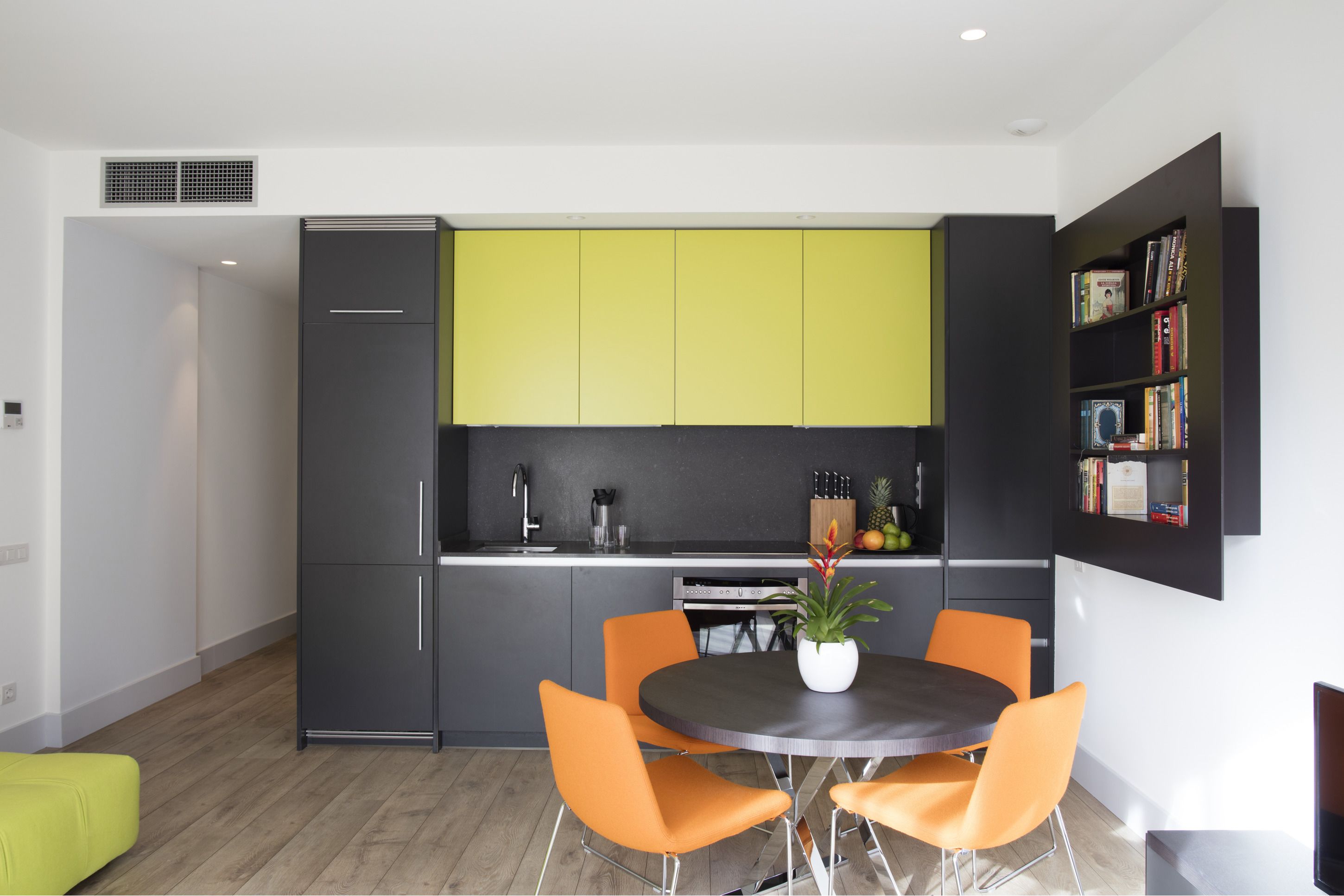 A modern kitchen with a dining area.