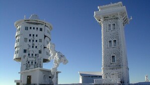 Two white, snow-covered buildings with multiple windows and a dome on one. - Wellnesshaus Waldmunchen (Waldmuenchen)