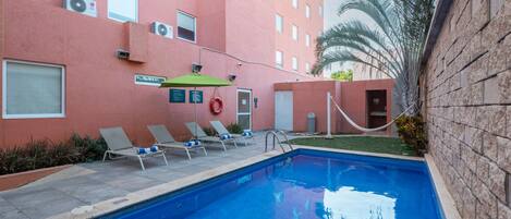 Outdoor pool, open 8:00 AM to 8:00 PM, pool loungers