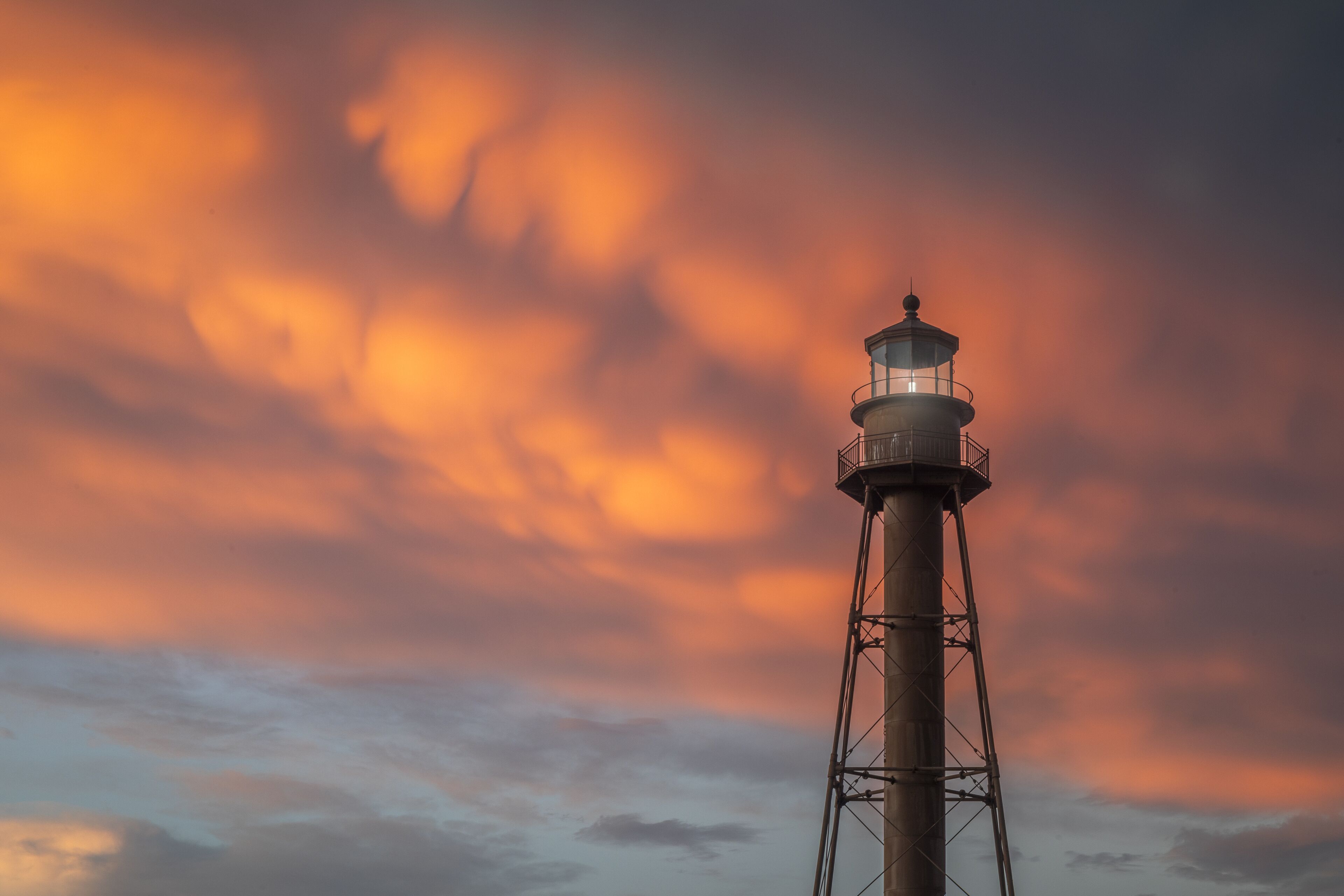 A lighthouse against a sunset sky.
