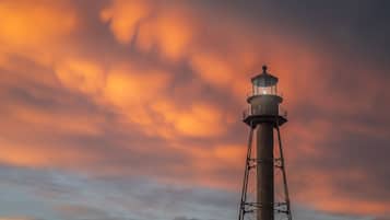 A lighthouse against a sunset sky.