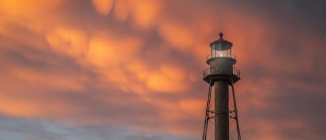 A lighthouse against a sunset sky.