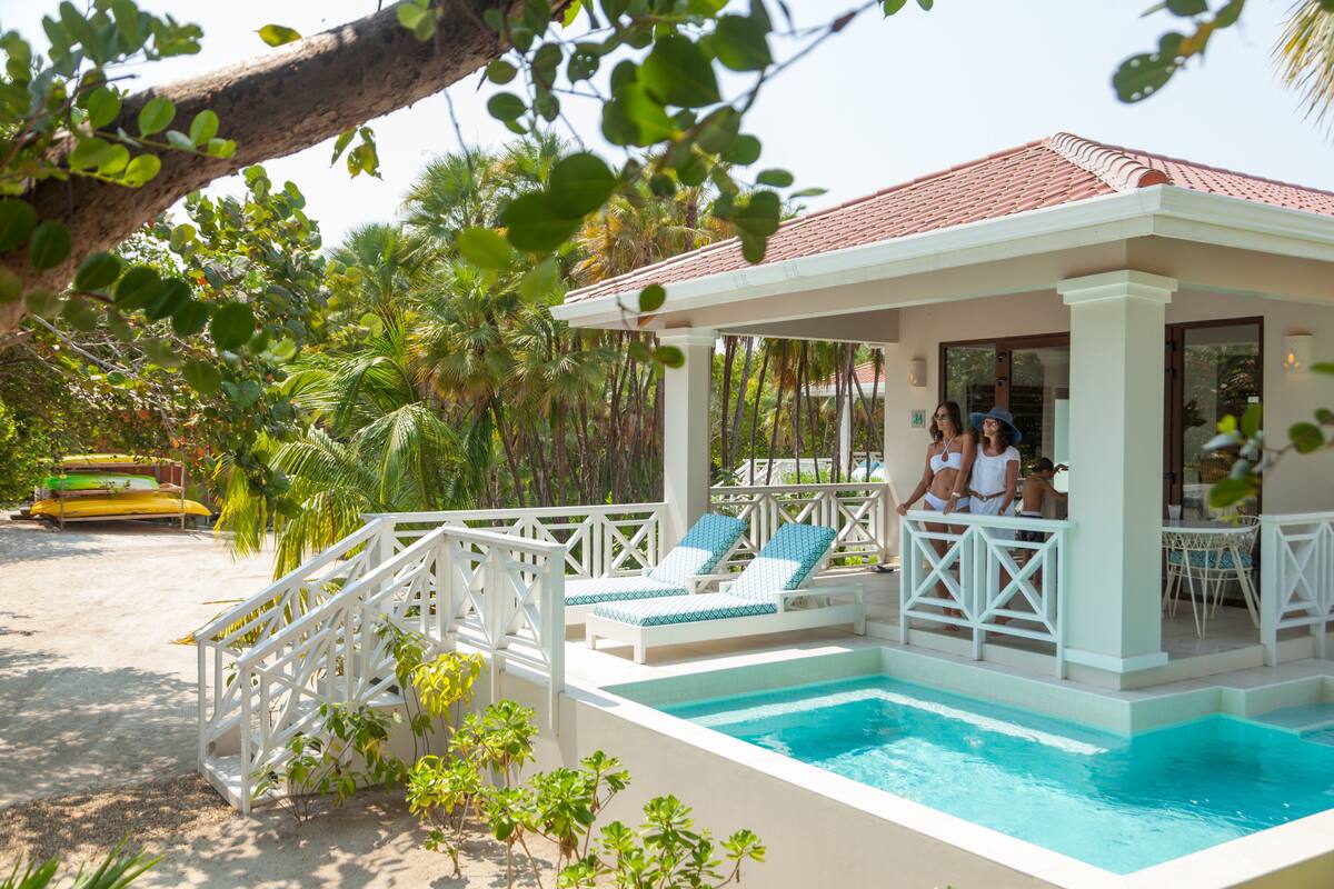 A poolside area with lounge chairs and a covered seating area.