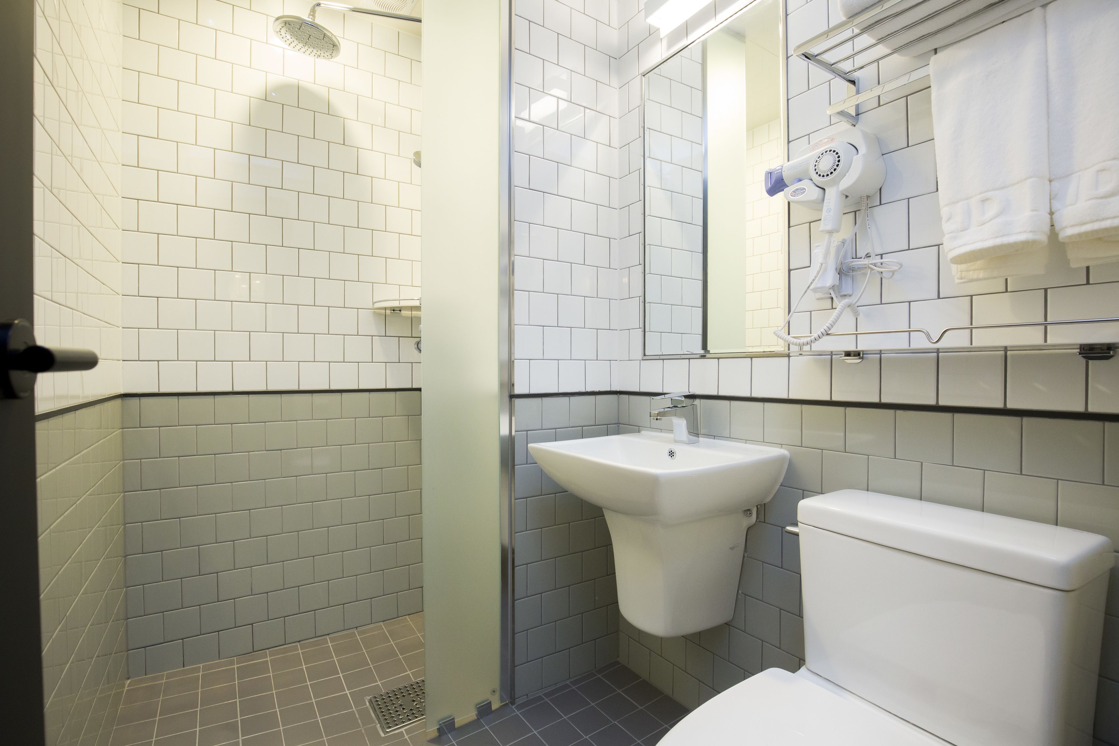 shower, hair dryer, slippers, towels