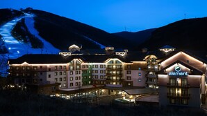 A large hotel with multiple buildings, a ski slope in the background, and a prominent "element" sign. - Element Chongli (Zhangjiakou)