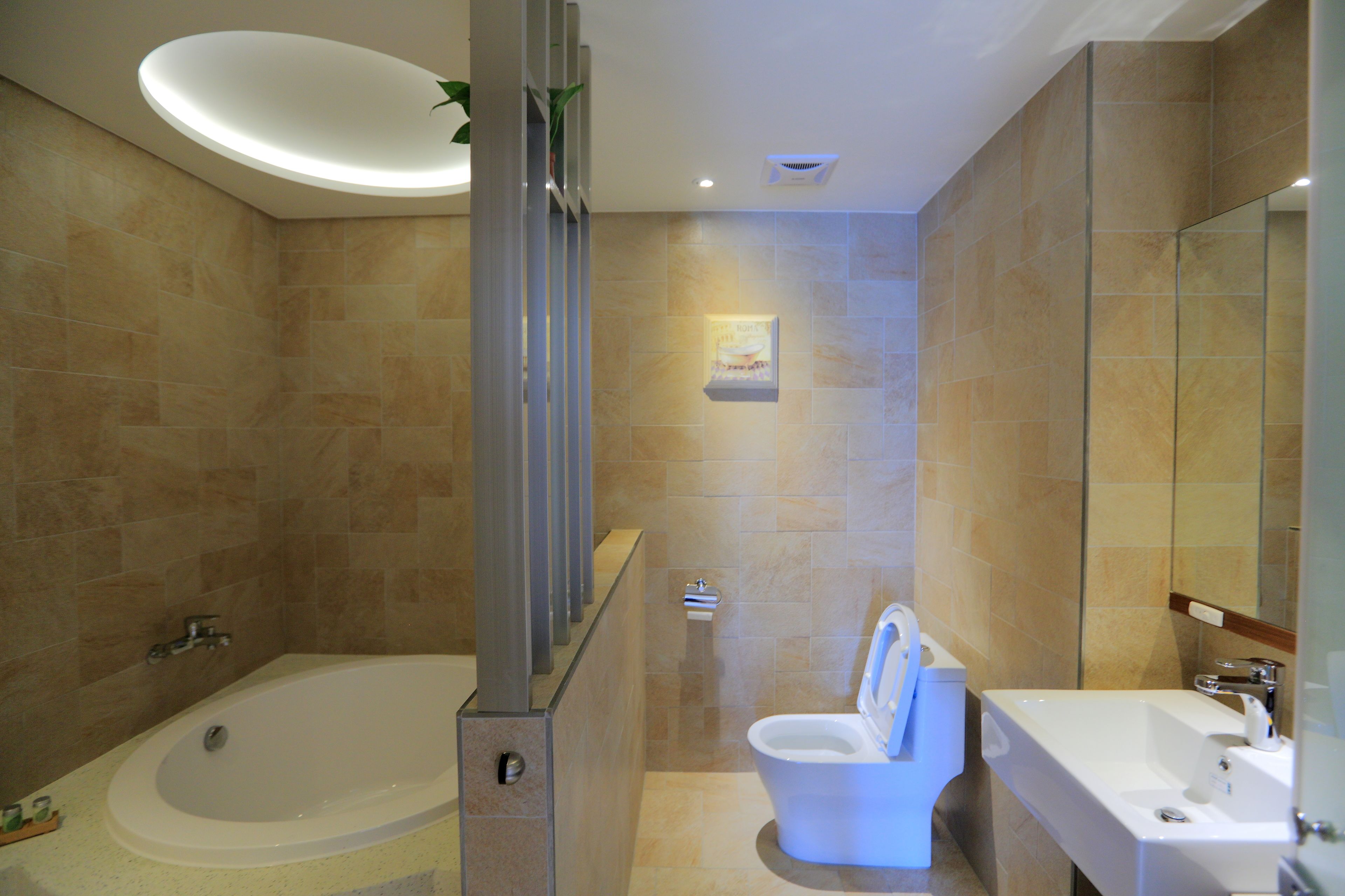 A modern bathroom with a bathtub, toilet, and sink.