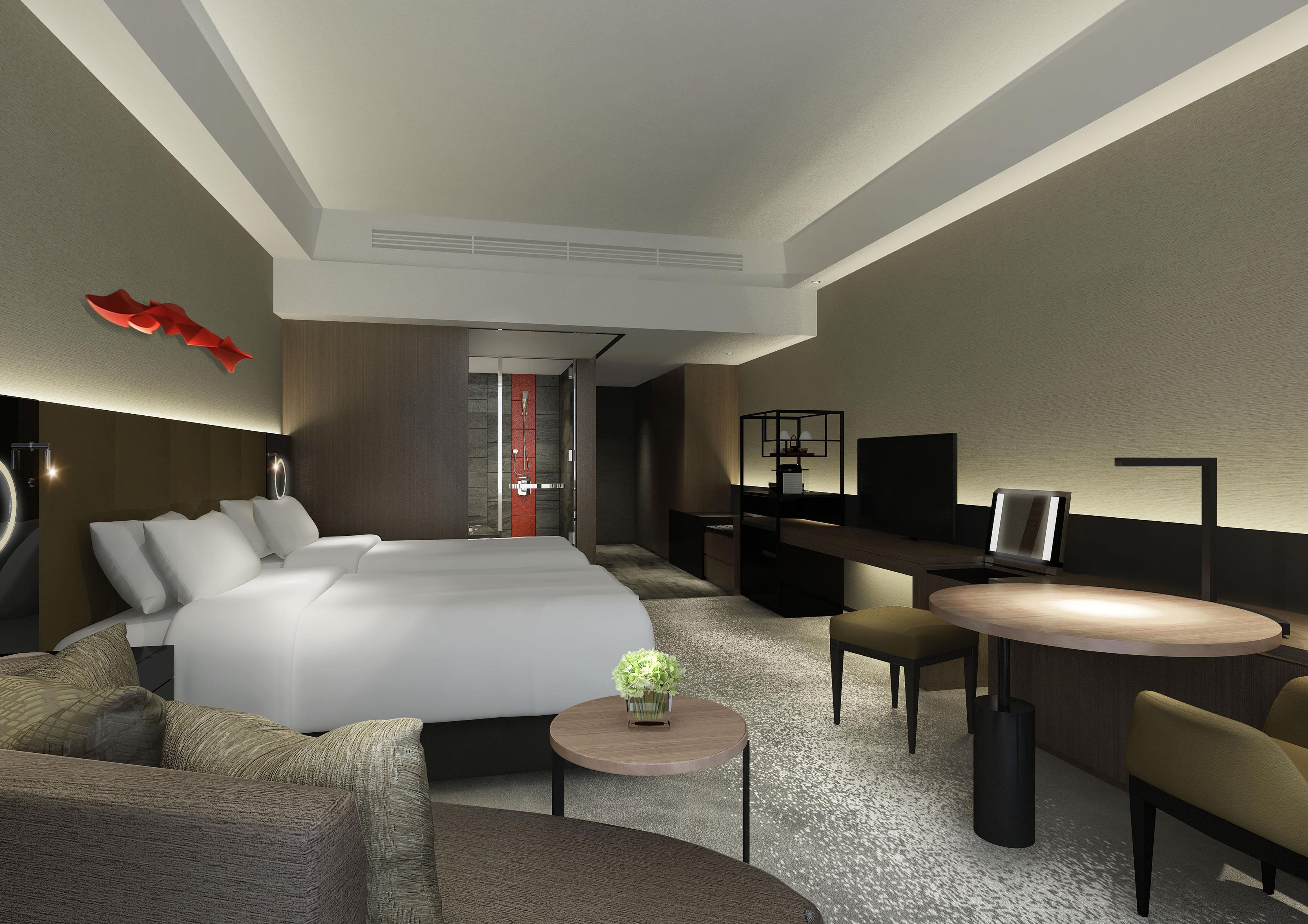 Une chambre d’hôtel moderne équipée d’un grand lit, d’un bureau, d’une télévision et d’un coin salon.