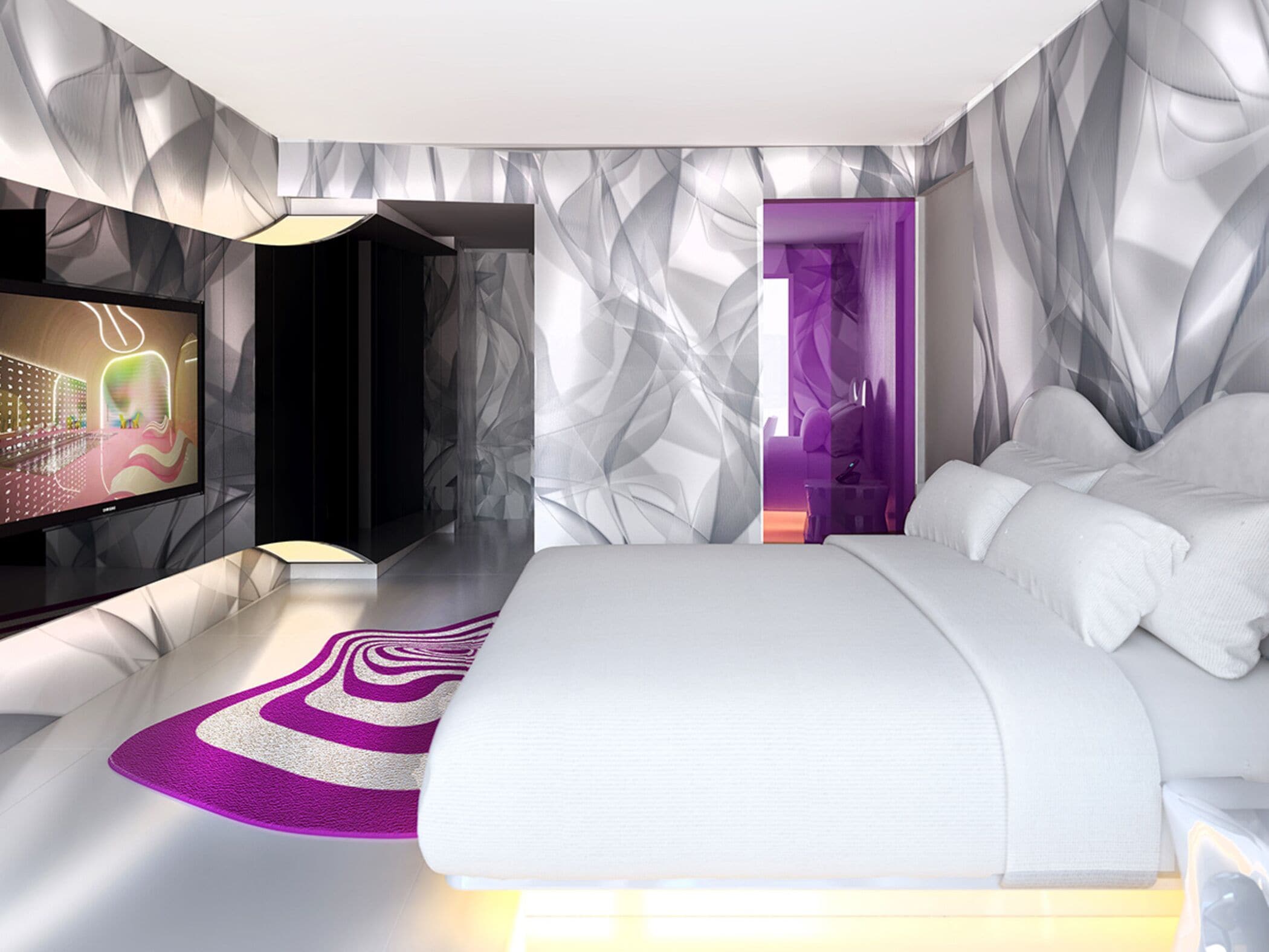 Une chambre moderne dotée d’un grand lit, d’une télévision et d’un décor mural géométrique original.
