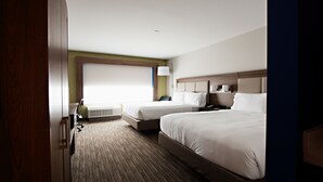 A hotel room with two beds, a large window, an air conditioning unit, and a bedside table with a lamp. - Holiday Inn Express & Suites Houston SW - Galleria Area by IHG (Houston)